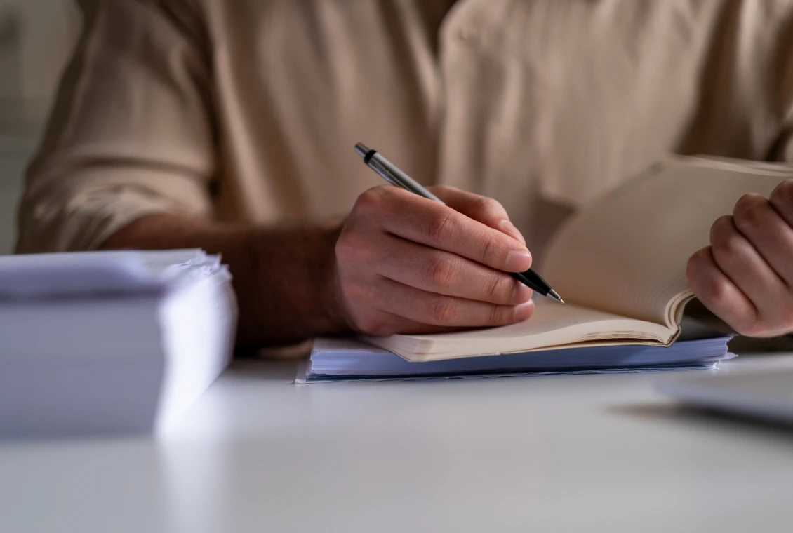 Writing notes at a desk